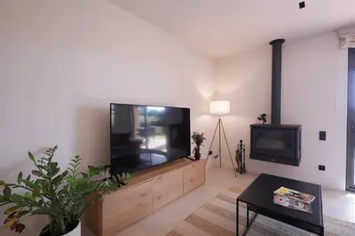 a living room with a large flat screen tv at Casa unifamiliar con jardín en la playa in Mareny Blau
