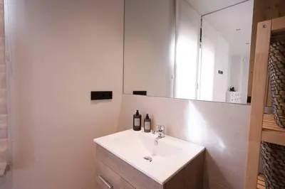 a bathroom with a white sink and a mirror at Casa unifamiliar con jardín en la playa in Mareny Blau