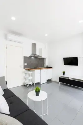 a white living room with a couch and a table at Your Apartment In The Center-Ruzafa 8C in Valencia