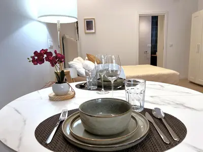 a table with a bowl and plates and wine glasses at PN4- Loft Valencia N4 Urban Ayora in Valencia