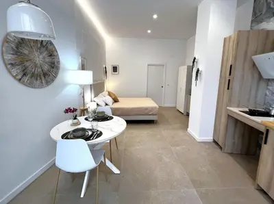 a living room with a table and a bed in a room at PN4- Loft Valencia N4 Urban Ayora in Valencia