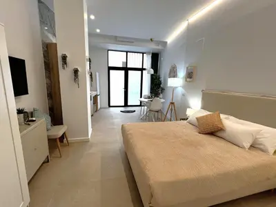 a bedroom with a large bed and a dining room at PN4- Loft Valencia N4 Urban Ayora in Valencia