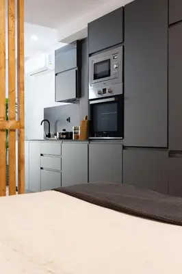 a kitchen with black and white cabinets and appliances at Valencia Leones by Concept Flats in Valencia