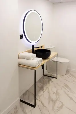 a bathroom with a sink and a mirror on a table at Valencia Leones by Concept Flats in Valencia
