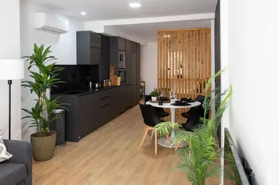 a kitchen and living room with a table and chairs at Valencia Leones by Concept Flats in Valencia