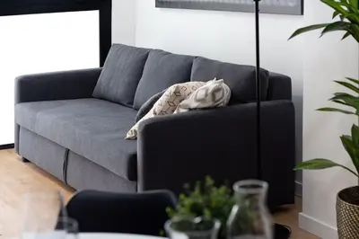 a gray couch in a living room with a table at Valencia Leones by Concept Flats in Valencia