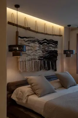 a bedroom with a bed with two pillows and a wall at Espacio Biocompatible - Villa Raíz in Requena