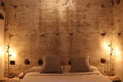 a bed in a room with a brick wall at Espacio Biocompatible - Villa Raíz in Requena