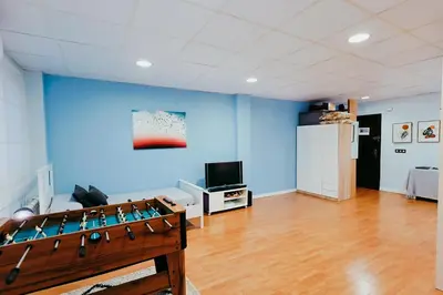 a living room with blue walls and a foosball at Fun Apt, City of Arts, ChillOut Zone, Soccer Table in Valencia