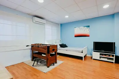 a living room with a table and a tv and a couch at Fun Apt, City of Arts, ChillOut Zone, Soccer Table in Valencia