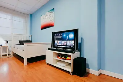 a living room with a flat screen tv on a stand at Fun Apt, City of Arts, ChillOut Zone, Soccer Table in Valencia