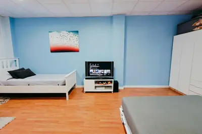 a room with two beds and a tv in it at Fun Apt, City of Arts, ChillOut Zone, Soccer Table in Valencia