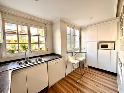 a kitchen with white cabinets and a sink at Seasonal Antonio Suárez in Valencia