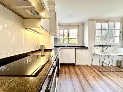 a kitchen with white cabinets and a counter top at Seasonal Antonio Suárez in Valencia