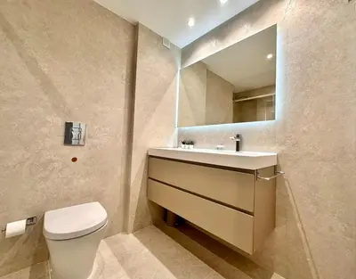 a bathroom with a toilet and a sink and a mirror at Seasonal Antonio Suárez in Valencia