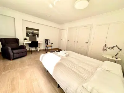 a bedroom with a bed and a chair and a desk at Seasonal Antonio Suárez in Valencia