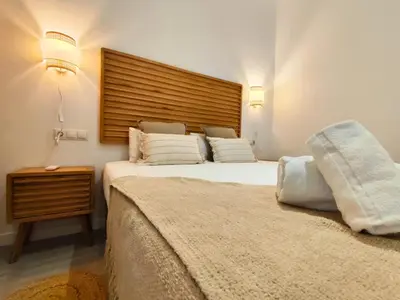 a bedroom with a large bed and a night stand at Travel Habitat Jesus-Patraix Familiar Apartment in Valencia