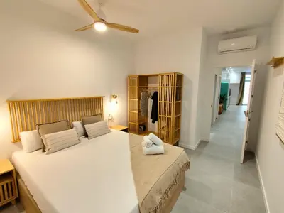 a bedroom with a large bed and a ceiling fan at Travel Habitat Jesus-Patraix Familiar Apartment in Valencia