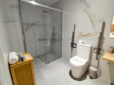 a bathroom with a glass shower and a toilet at Travel Habitat Jesus-Patraix Familiar Apartment in Valencia