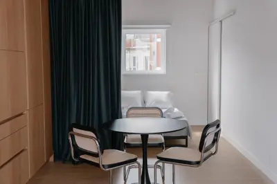 a table and chairs in a room with a couch at Burriana X - Estudio in Valencia