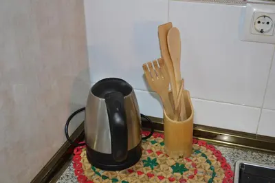 a coffee pot and wooden utensils on a counter at Pobla de Farnals BEACH APARTMENT in Puebla de Farnals