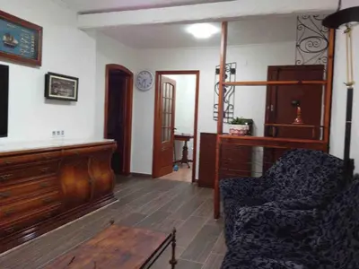 a living room with a piano and a chair at Beach apartment in Valencia
