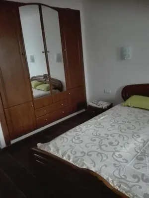 a bedroom with a bed and a dresser with a mirror at Beach apartment in Valencia