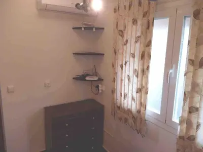 a room with a window and a dresser at Beach apartment in Valencia