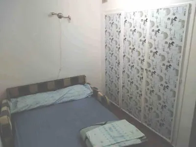 a small room with a bed and a curtain at Beach apartment in Valencia