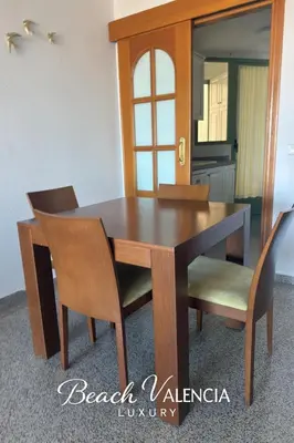 a wooden dining room table with chairs and a mirror at BEACH VALENCIA LUXURY D7-21 Apartment with terrace and sea views with two rooms in Valencia
