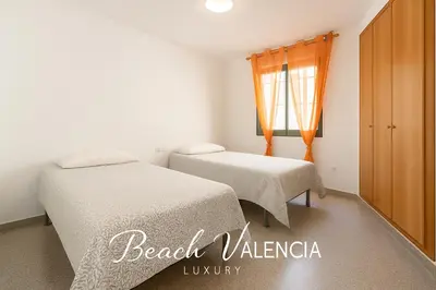 a bedroom with two beds and a window at BEACH VALENCIA LUXURY D7-21 Apartment with terrace and sea views with two rooms in Valencia