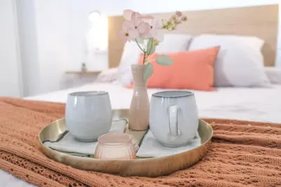 a tray with two cups and a vase with flowers at Suite near to Marathon - City of Arts & Sciences in Valencia