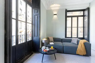 a living room with a blue couch and a table at Apartment 2 bedroom Historical Center in Valencia