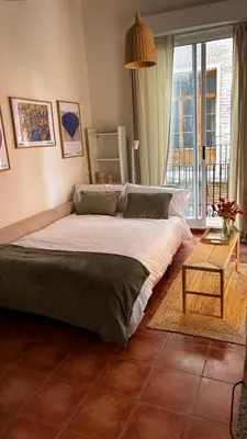 a large bed in a room with a large window at Estudio recién decorado en el mejor centro histórico in Valencia
