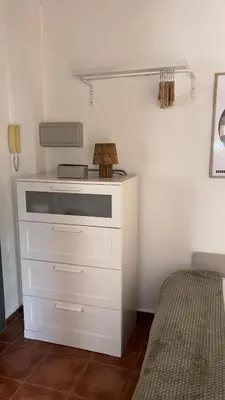 a white dresser in a bedroom with a bed at Estudio recién decorado en el mejor centro histórico in Valencia