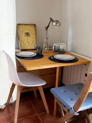 a wooden table with two plates and a clock on it at Estudio recién decorado en el mejor centro histórico in Valencia