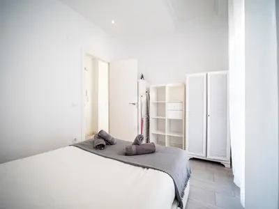 a white bedroom with a bed with towels on it at Apartment Ruzafa Market 9C in Valencia