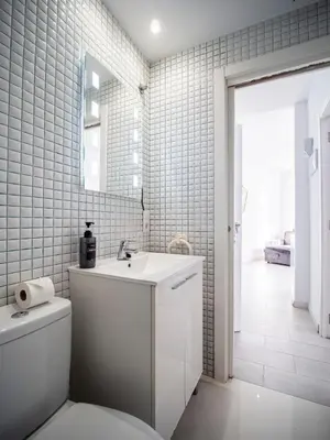 a bathroom with a white sink and a toilet at Apartment Ruzafa Market 9C in Valencia