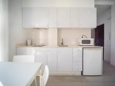 a white kitchen with white cabinets and a microwave at Apartment Ruzafa Market 9C in Valencia