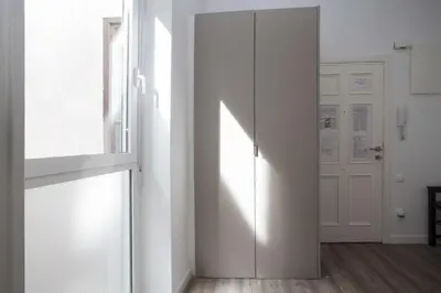 a hallway with a sliding door and a window at Quart Apartment in Valencia