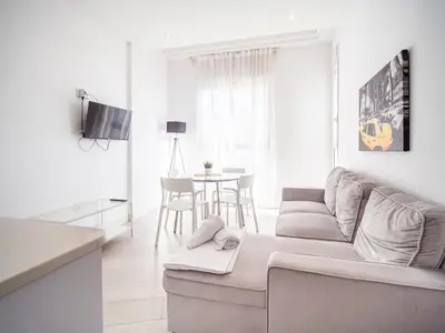 a white living room with a couch and a table at Tu Apartamento En El Centro-Ruzafa 9D in Valencia
