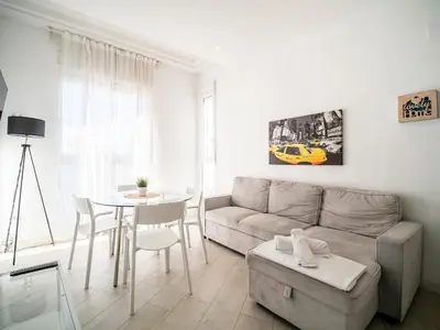 a living room with a couch and a table at Tu Apartamento En El Centro-Ruzafa 9D in Valencia