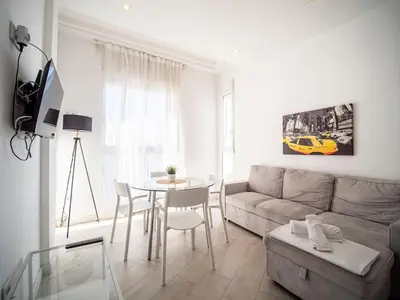 a living room with a couch and a table at Tu Apartamento En El Centro-Ruzafa 9D in Valencia