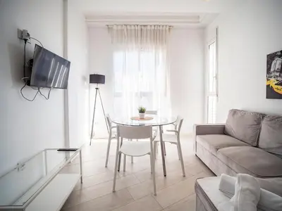a living room with a table and a couch at Tu Apartamento En El Centro-Ruzafa 9D in Valencia
