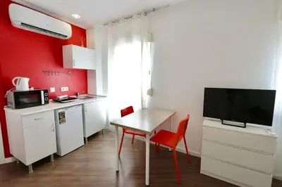 a bedroom with a bed and a table and a desk at Tu Estudio En El Centro-Ruzafa 10A in Valencia