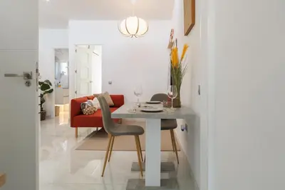 a dining room with a table and a red couch at Top Floor 2 Bedroom Apartment with Terrace in Valencia