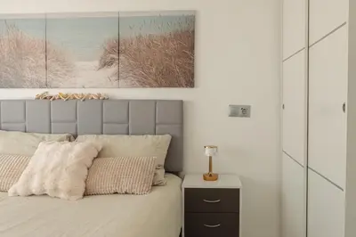 a bedroom with a bed with a picture on the wall at Top Floor 2 Bedroom Apartment with Terrace in Valencia