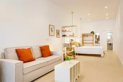 a living room with a couch and a bed at B - Design apartment at El Grao close to the beach in Valencia