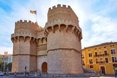 a large castle with a flag on top of it at Ático Exclusivo del Siglo XVI con Dos Terrazas en el Corazón de Ciutat Vella in Valencia