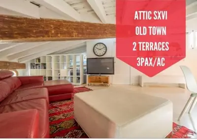 a living room with a couch and a clock on a wall at Ático Exclusivo del Siglo XVI con Dos Terrazas en el Corazón de Ciutat Vella in Valencia